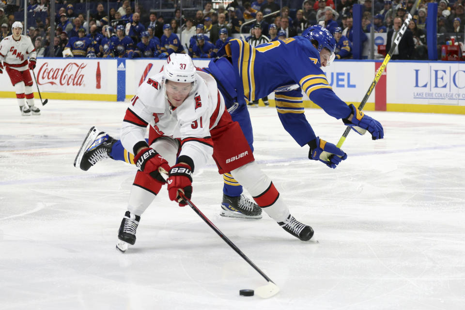 Buffalo Sabres right wing Tage Thompson, right, and Carolina Hurricanes right wing Andrei Svechnikov (37) collide during the first period of an NHL hockey game Sunday, Feb. 25, 2024, in Buffalo, N.Y. (AP Photo/Jeffrey T. Barnes)