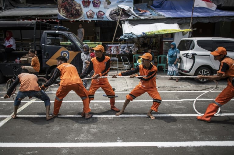 Indonesian workers play a tug-of-war game as part of the 2018 Asian Games in Jakarta