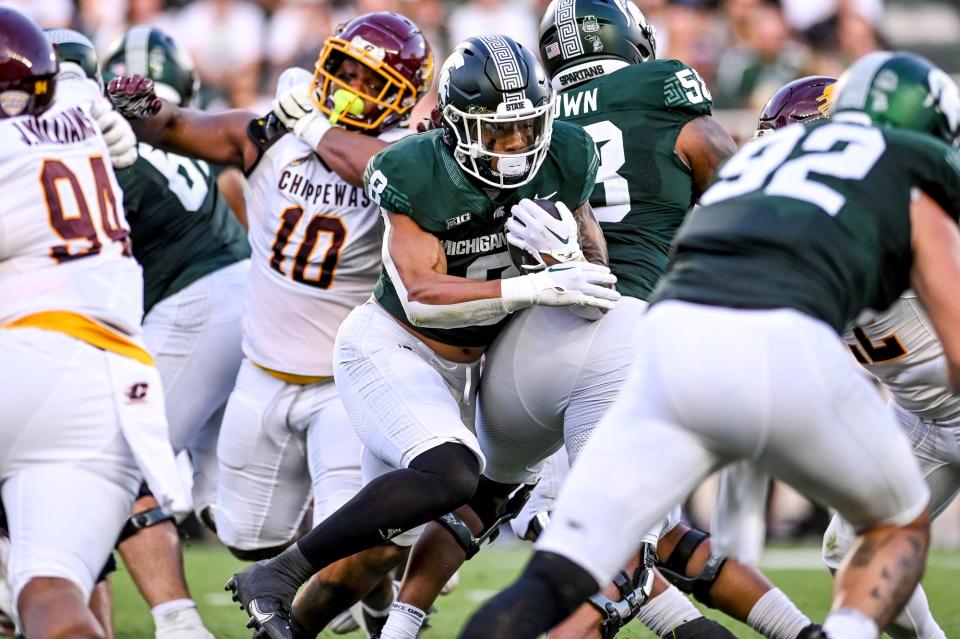 Michigan State's Jalen Berger, center, runs for a gain against Central Michigan during the first quarter on Friday, Sept. 1, 2023, at Spartan Stadium in East Lansing.