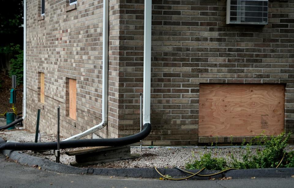 Windows are boarded up in the lower apartments at Dean Estates after catastrophic flooding in September.