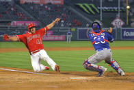 Los Angeles Angels' Scott Schebler, left, scores on a sacrifice fly hit by David Fletcher as Texas Rangers catcher Jose Trevino takes a late throw during the third inning of a baseball game Tuesday, April 20, 2021, in Anaheim, Calif. (AP Photo/Mark J. Terrill)