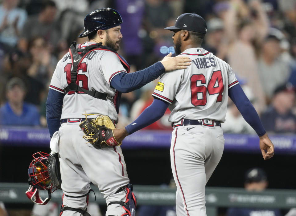 Atlanta Braves catcher Travis d'Arnaud, left, congratulates starting pitcher Darius Vines as they head to the dugout after the sixth inning of a baseball game against the Colorado Rockies Wednesday, Aug. 30, 2023, in Denver. (AP Photo/David Zalubowski)