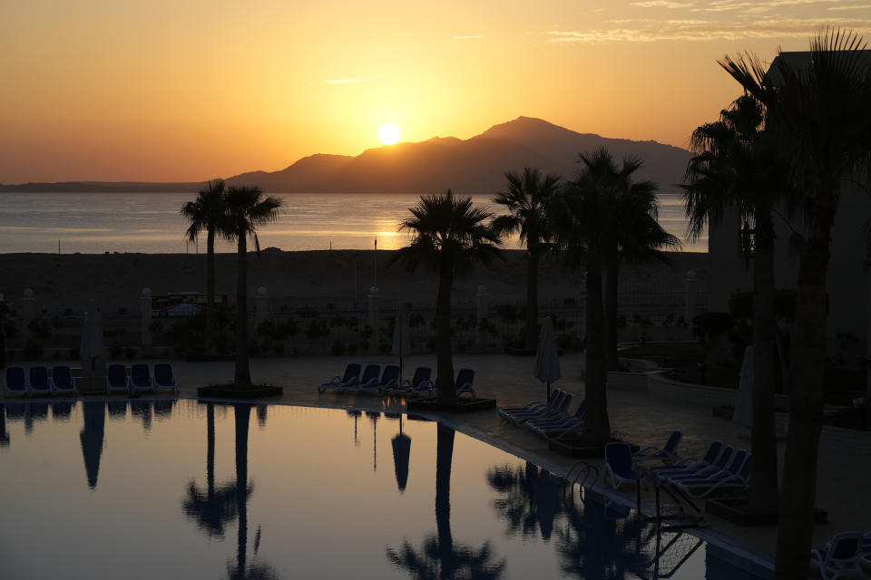 The sun rises over the beach during the COP27 U.N. Climate Summit, Tuesday, Nov. 8, 2022, in Sharm el-Sheikh, Egypt. (AP Photo/Peter Dejong)