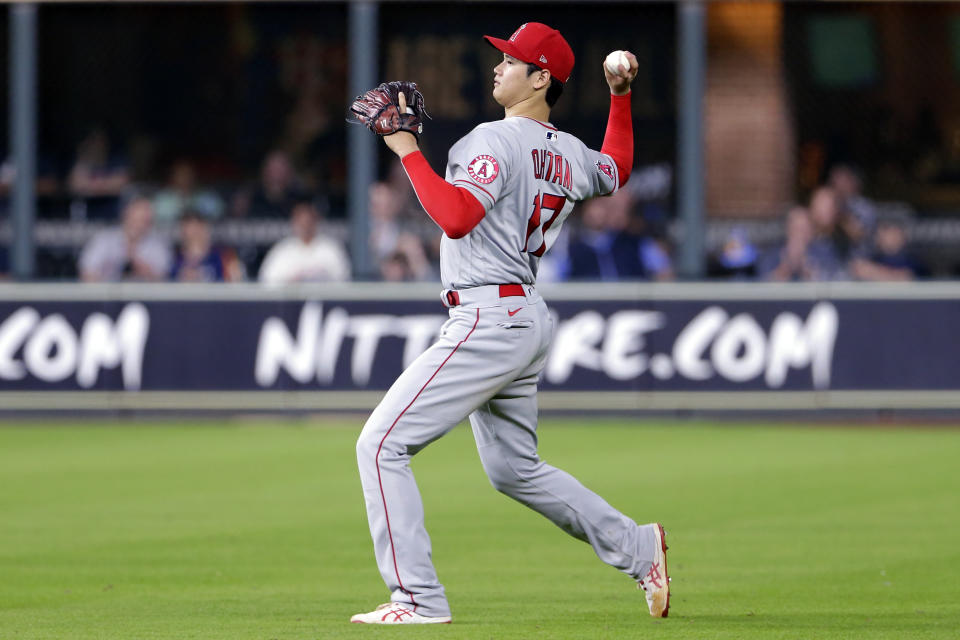 After switching to right field after pitching seven innings, Los Angeles Angels' Shohei Ohtani (17) fields the single by Houston Astros' Aledmys Diaz during the eighth inning of a baseball game Tuesday, May 11, 2021, in Houston. (AP Photo/Michael Wyke)