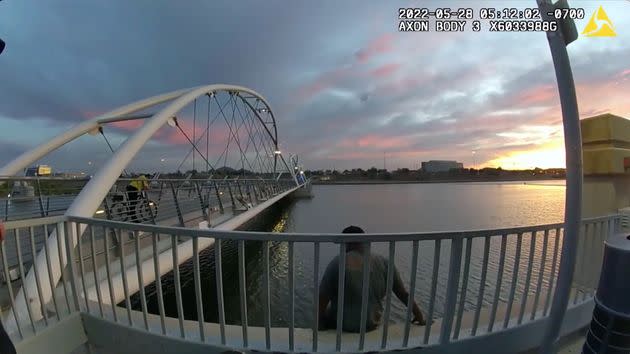 Bickings climbed over a fence to enter the water, as seen here in an image from police body camera footage. He then swam several yards out from shore. (Photo: tempe.gov)