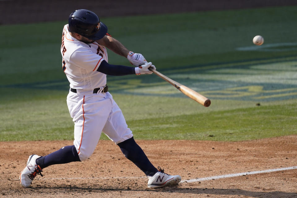 Houston Astros' Jose Altuve hits a two-run home run against the Oakland Athletics during the seventh inning of Game 4 of a baseball American League Division Series in Los Angeles, Thursday, Oct. 8, 2020. (AP Photo/Ashley Landis)