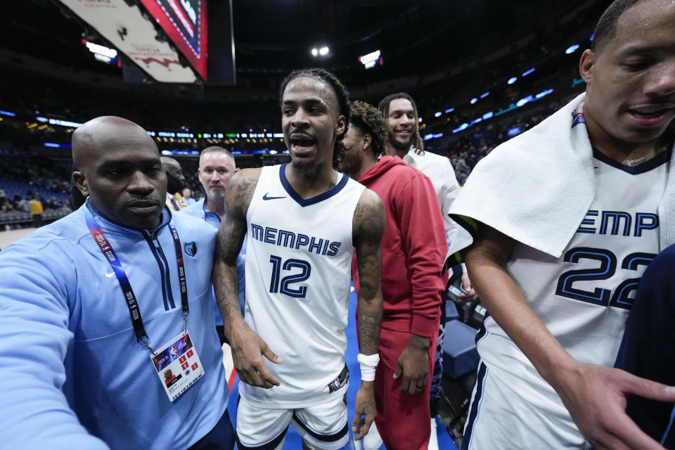 Memphis Grizzlies guard Ja Morant (12) celebrates after scoring the game-winning basket at the buzzer in the second half of an NBA basketball game against the New Orleans Pelicans in New Orleans, Tuesday, Dec. 19, 2023. The Grizzlies won 115-113. (AP Photo/Gerald Herbert)