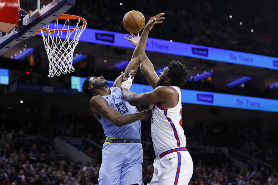 Philadelphia 76ers' Joel Embiid, right, goes up for a shot against Memphis Grizzlies' Jaren Jackson Jr. during the first half of an NBA basketball game Friday, Feb. 7, 2020, in Philadelphia. (AP Photo/Matt Slocum)