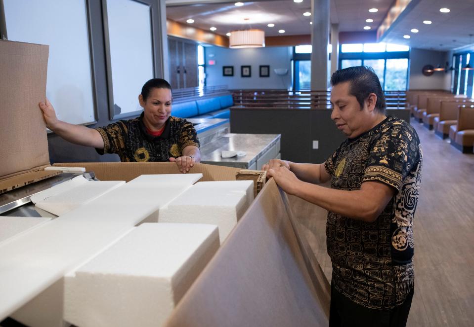 Gerardo Zentle and his wife, Reina Medina, unpack supplies for the couple's new Xiscali Taqueria location on Navy Boulevard on Wednesday, Nov. 23, 2022. The restaurant will open in early December in the old IHOP building at the corner of Navy Boulevard and Gulf Beach Highway.