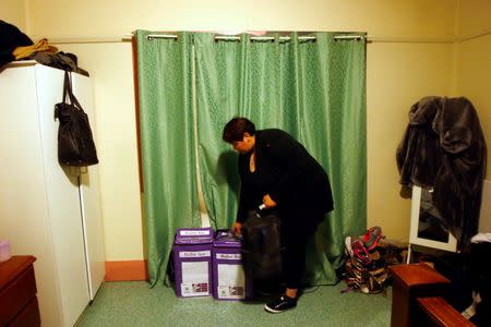 Australian Electoral Commission official and team leader Kelly-Anne Mackay checks ballot boxes containing votes, which she keeps secure in the bedroom of her home located in the town of Bourke, after returning from a remote voting station located in the western New South Wales outback town of Enngonia, Australia, June 22, 2016. REUTERS/David Gray