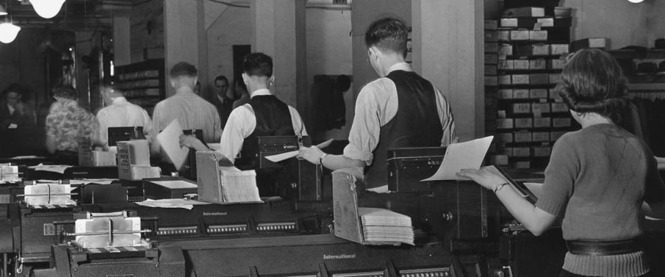 Social Security Administration clerks seated at massive tabulating machines in the Social Security system. Ca. 1940.