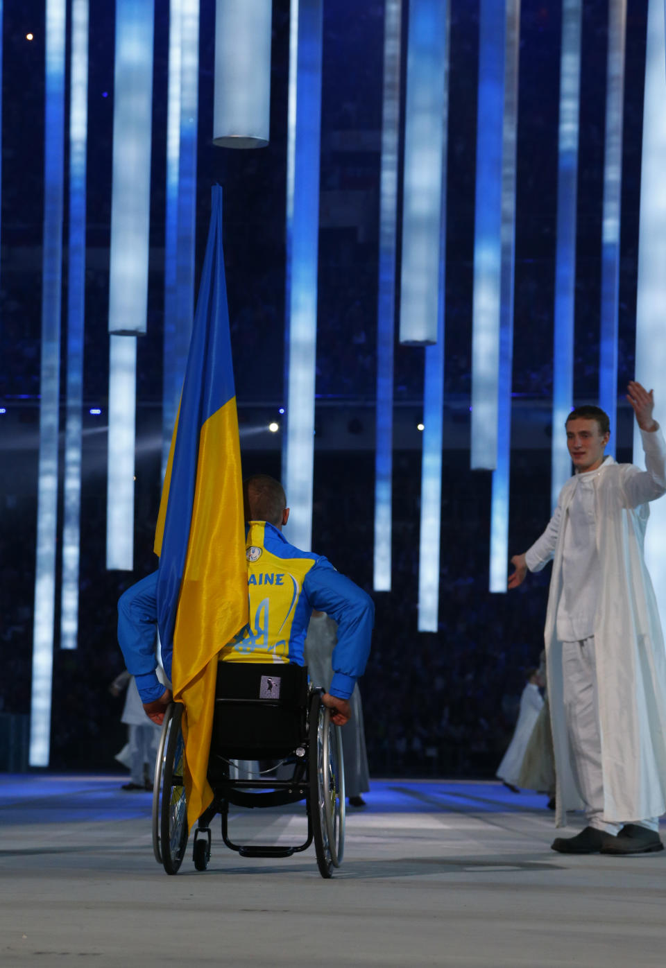 CAPTION ADDS NAME OF ATHLETE - Biathelete Mykhaylo Tkachenko, representing Ukraine, enters the arena during the opening ceremony of the 2014 Winter Paralympics at the Fisht Olympic stadium in Sochi, Russia, Friday, March 7, 2014. (AP Photo/Dmitry Lovetsky)