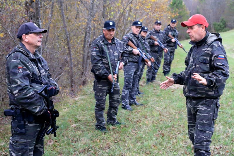 FILE PHOTO: Andrej Sisko leader of Stajerska Varda (Stajerska Guard) speaks to uniformed volunteers while they hold exercises near the border with Croatia in Kostel