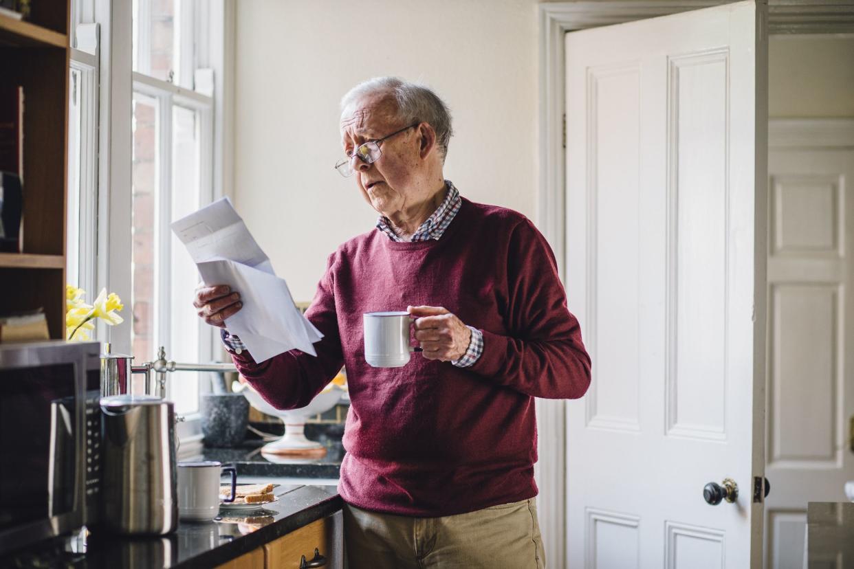 senior man looking at financial paper