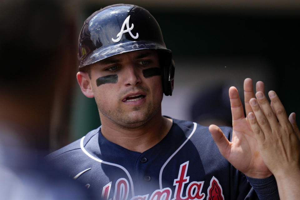 Atlanta Braves' Austin Riley celebrates with teammates after scoring on a single hit by Sean Murphy during the third inning of a baseball game against the Cincinnati Reds, Sunday, June 25, 2023, in Cincinnati. (AP Photo/Jeff Dean)