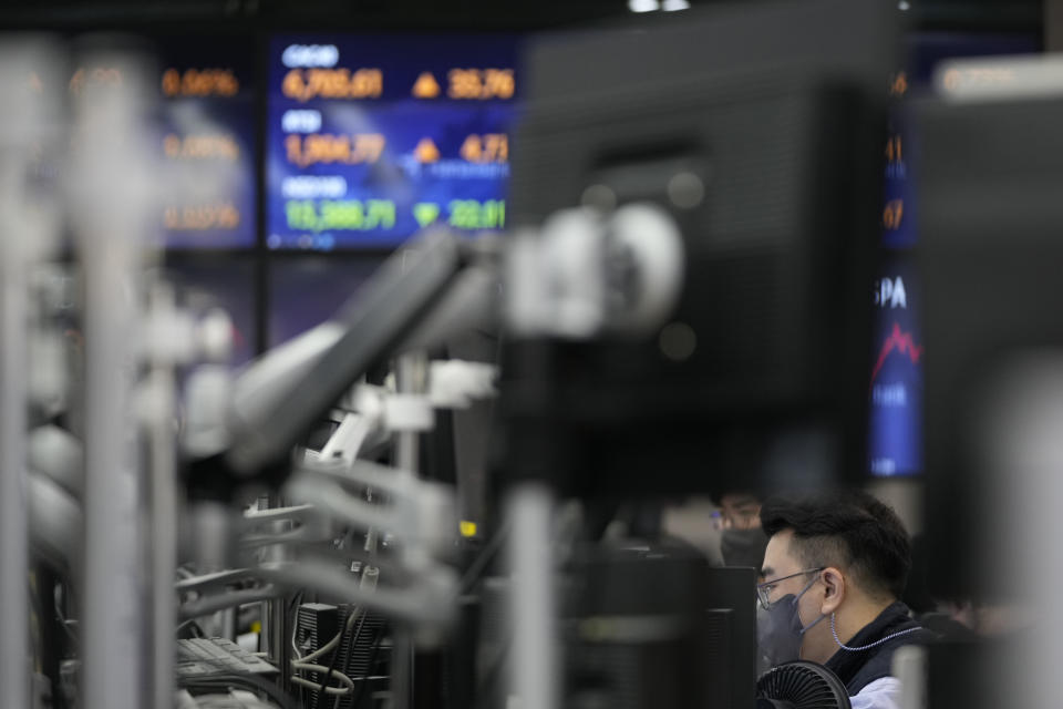Currency traders watches computer monitors near the screens at a foreign exchange dealing room in Seoul, South Korea, Thursday, Oct. 21, 2021. Shares are mixed in Asia after major Chinese property developer Evergrande said a plan to sell its property management arm to a smaller rival had fallen through. (AP Photo/Lee Jin-man)
