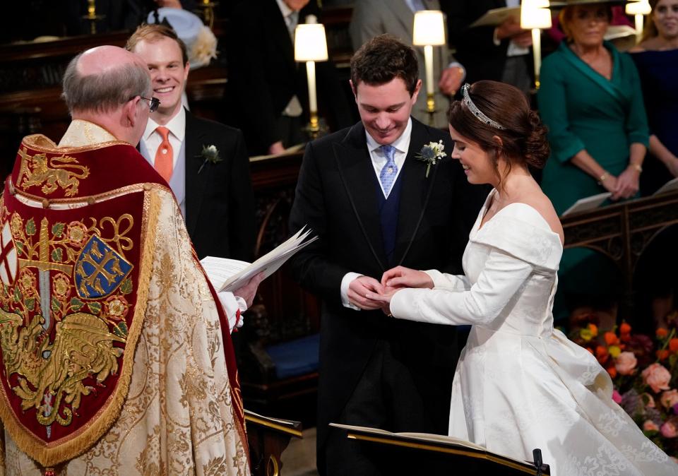 Princess Eugenie smiles as Jack Brooksbank put the ring on her finger during their wedding ceremony at St George's Chapel in Windsor Castle on October 12, 2018 in Windsor, England