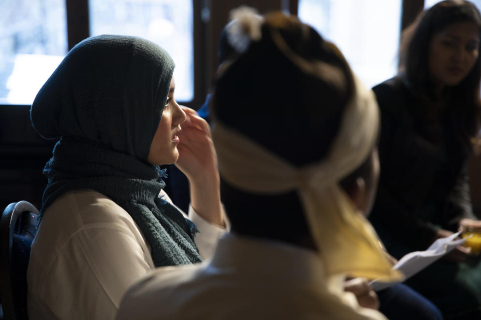 Yasmin Ullah, left, and other representatives of the Rohingya community take their seats for "Right of Reply" meeting after two days of hearings at the International Court of Justice in The Hague, Netherlands, Wednesday, Dec. 11, 2019. Myanmar leader Aung San Suu Kyi defended Myanmar Wednesday and denied genocide accusations against the Rohingya Muslim minority in a case filed by Gambia at the ICJ, the United Nations' highest court. (AP Photo/Peter Dejong)