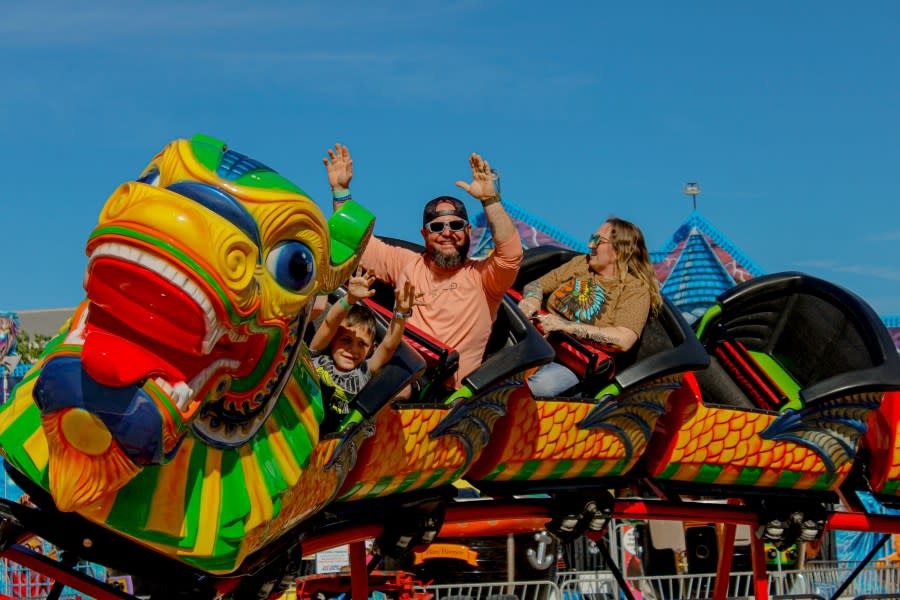 A family enjoying a rollercoaster at the Western Financial Carnival.