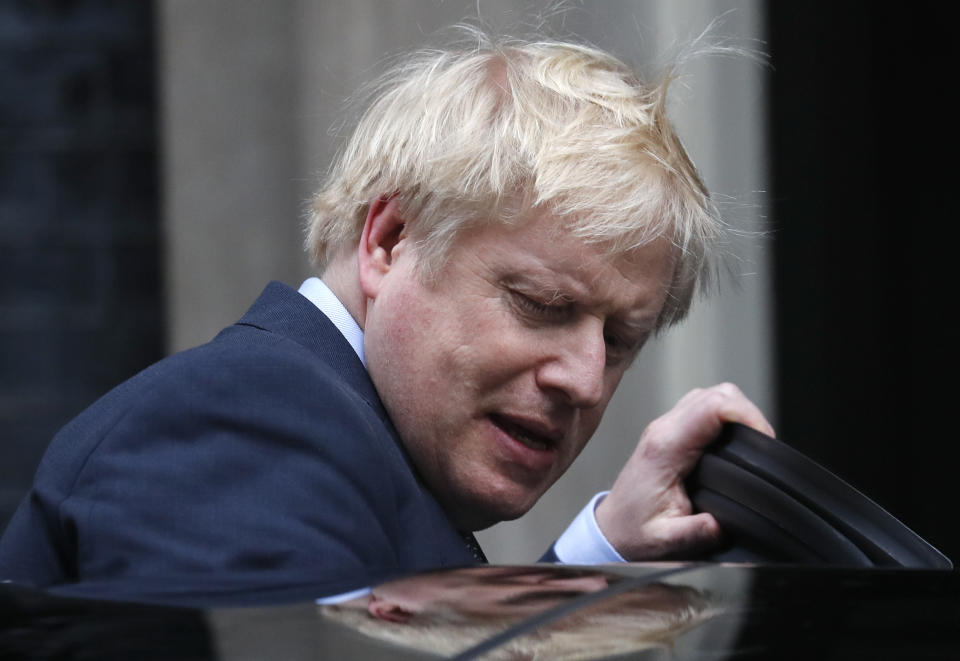 Britain's Prime Minister Boris Johnson leaves number 10 Downing Street in London, Friday, Dec. 13, 2019 on his way to meet Queen Elizabeth II to seek her approval to form a new government. Prime Minister Boris Johnson's Conservative Party has won a solid majority of seats in Britain's Parliament — a decisive outcome to a Brexit-dominated election that should allow Johnson to fulfill his plan to take the U.K. out of the European Union next month. (AP Photo/Frank Augstein)