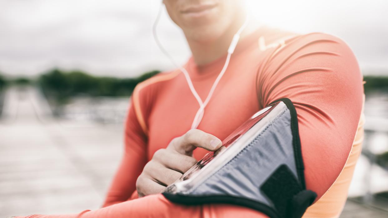  A woman looking at a running app on her smartphone. 