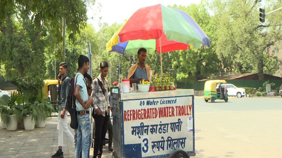 Kali Prasad sells water and lemon juice outside the India Gate in New Delhi on May 30, 2024. - Vijay Bedi/CNN