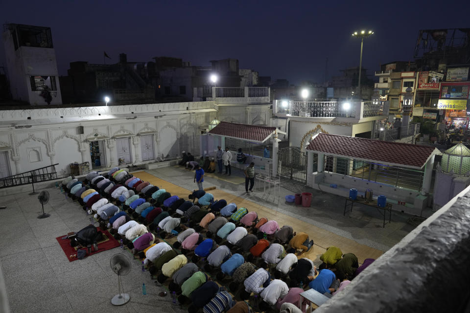 Muslims offer evening prayers before breaking their Ramadan fast at a Mosque, in Ayodhya, India, March 28, 2023. India is home to some two hundred million Muslims who make up the predominantly Hindu country's largest minority group. They are scattered across almost every part of India where a systematic anti-Muslim fury has swept since Prime Minister Narendra Modi first assumed power in 2014. (AP Photo/Manish Swarup)