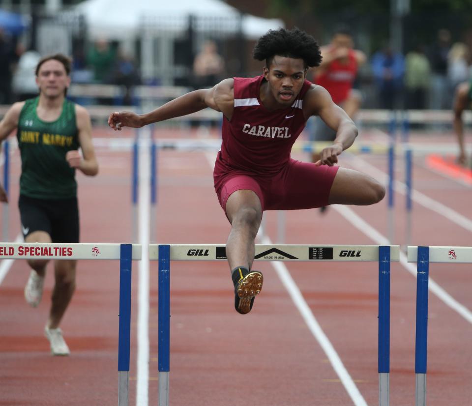 Caravel's Donovan Dixon leaps the final hurdle on his way to winning his second hurdles event of the day, the Division II 300 meter hurdles, during the second day of the DIAA state high school track and field championships at Dover High School, Saturday, May 18, 2024.