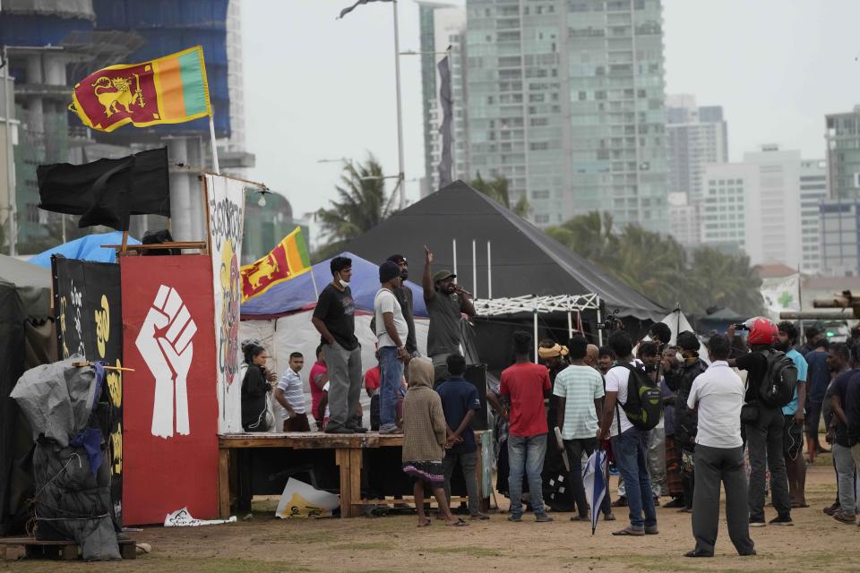 Anti-government protesters shout slogans against electing Ranil w'ickremesinghe as president at the ongoing protest site in Colombo, Sri Lanka, Wednesday, Aug. 3, 2022. Sri Lanka's new president says his government is preparing a national policy roadmap for the next 25 years that aims to cut public debt and turn the country into a competitive export economy as it seeks a way out of its worst economic disaster. (AP Photo/Eranga Jayawardena)