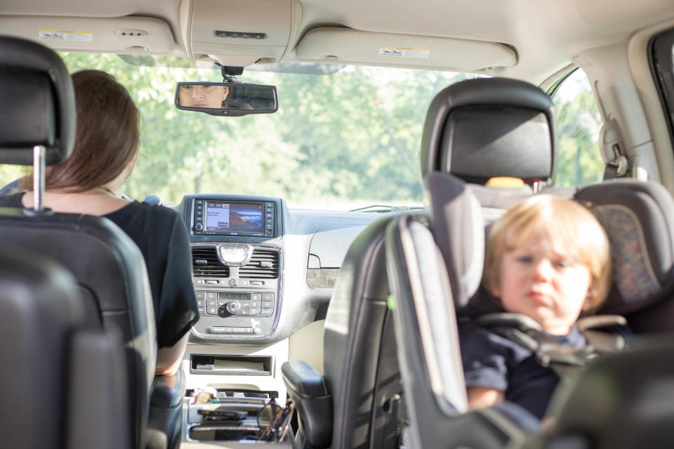 Renly Andreasen sits in his car seat while his mother drives.