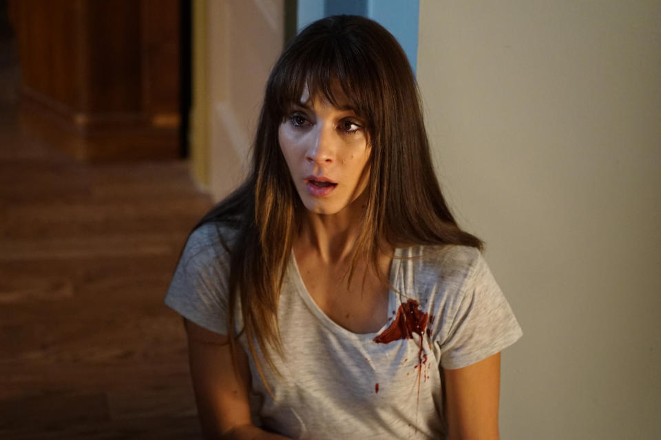Spencer in "Pretty Little Liars" wearing bloody shirt and looking shocked
