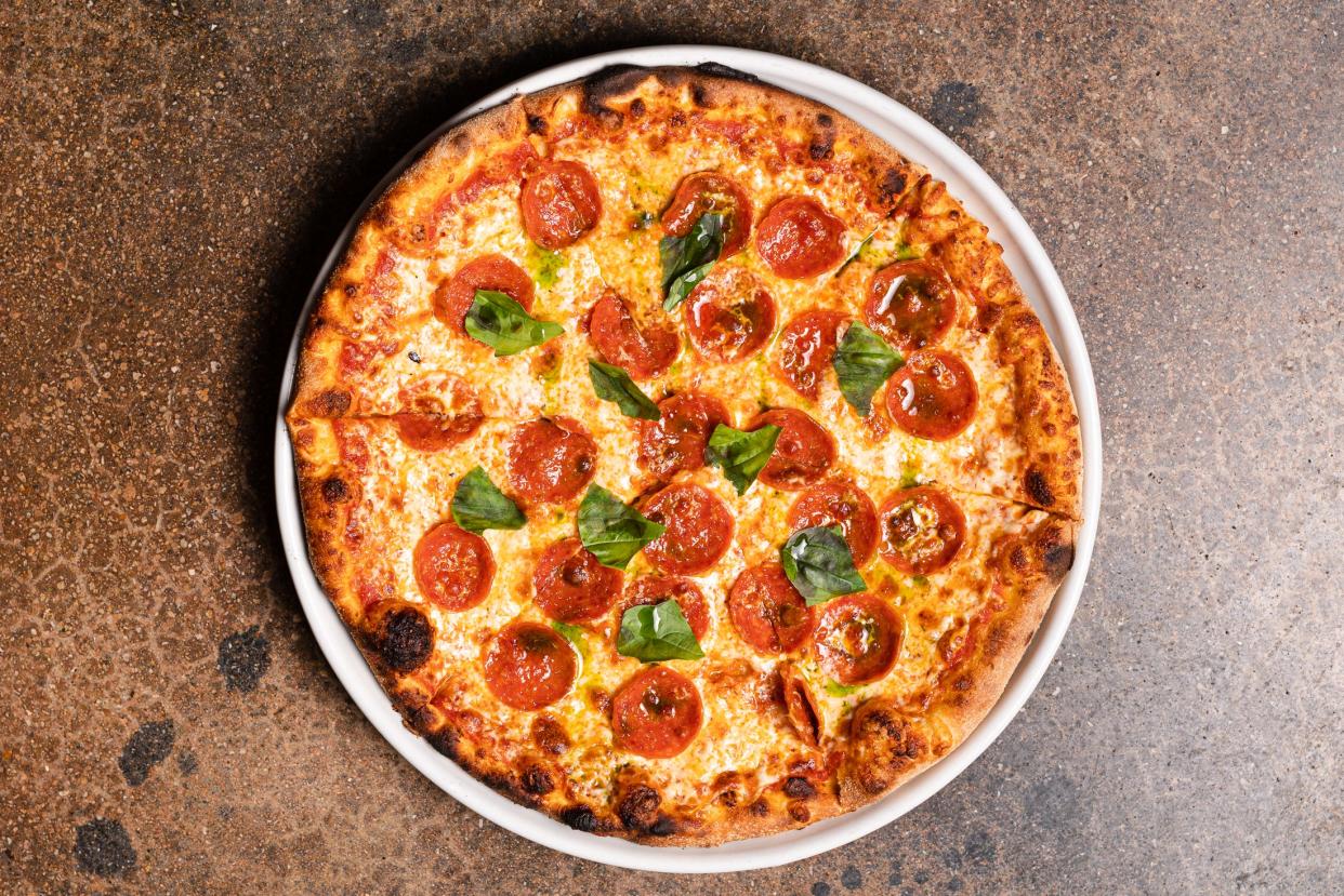 On the menu at Prezzo, an arrabbiata pizza is topped with Calabrian chili tomato sauce, pepperoni, mozzarella, basil and basil-infused extra-virgin olive oil.