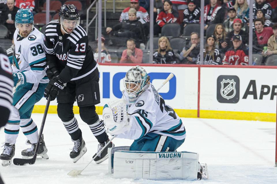 San Jose Sharks goaltender Kaapo Kahkonen (36) makes a glove save in front of defenseman Mario Ferraro (38) and New Jersey Devils center Nico Hischier (13) during the third period at Prudential Center on Friday night. The Devils lost the game, 6-3.