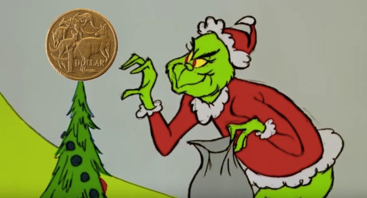 The Grinch stealing a $1 coin off the top of a Christmas tree.