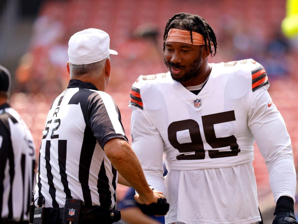 Myles Garrett speaks with an official before a preseason game.