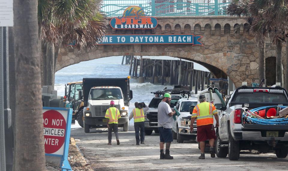 Daytona Beach Public Works employees make repairs to a water line to the Daytona Pier, Saturday, Nov. 12, 2022, as cleanup and repairs continue following Tropical Storm Nicole.