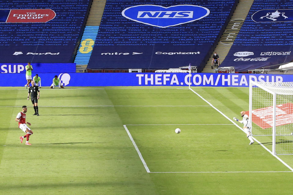 Arsenal's Pierre-Emerick Aubameyang scores his side's first goal from the penalty spot, during the FA Cup final soccer match between Arsenal and Chelsea at Wembley stadium in London, England, Saturday, Aug.1, 2020. (Catherine Ivill/Pool via AP)