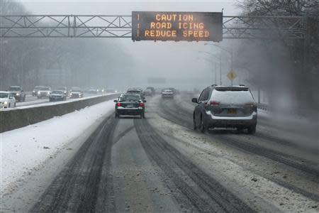 A digital traffic advisory warns of icy roads along the Grand Central Parkway in the Queens borough of New York, January 21, 2014. REUTERS/Shannon Stapleton