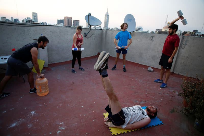 People exercise on a roof as the spread of the coronavirus disease (COVID-19) continues in Mexico City