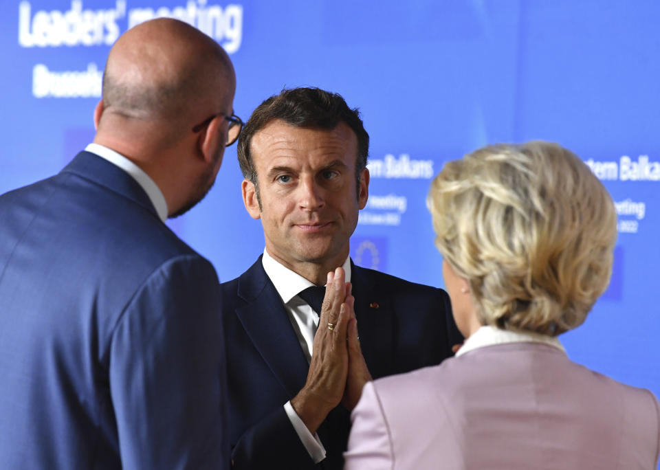 FILE - European Commission President Ursula von der Leyen, right, speaks with French President Emmanuel Macron, center, and European Council President Charles Michel prior to a group photo with Western Balkan leaders at an EU summit in Brussels, Thursday, June 23, 2022. Emmanuel Macron is badly weakened at home after parliamentary elections cost his party its majority - but his domestic headaches look unlikely to clip his wings on the world stage or threaten his international agenda. (John Thys, Pool Photo via AP, File)