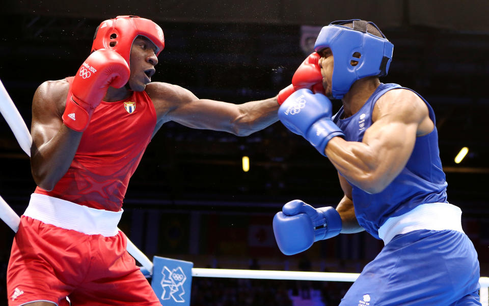 LONDON, ENGLAND - AUGUST 01: Anthony Joshua of Great Britain (R) in action with Erislandy Savon Cotilla of Cuba during the Men's Super Heavy ( 91kg) Boxing on Day 5 of the London 2012 Olympic Games at ExCeL on August 1, 2012 in London, England. (Photo by Scott Heavey/Getty Images)