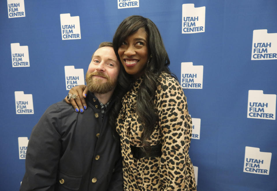 In this May 3, 2019, photo, Aaron Ruell, who played the character Kip, and Shondrella Avery, who played LaFawnduh, hug during a photo-op as they celebrate the 15th anniversary of "Napoleon Dynamite," in Salt Lake City. (AP Photo/Rick Bowmer)