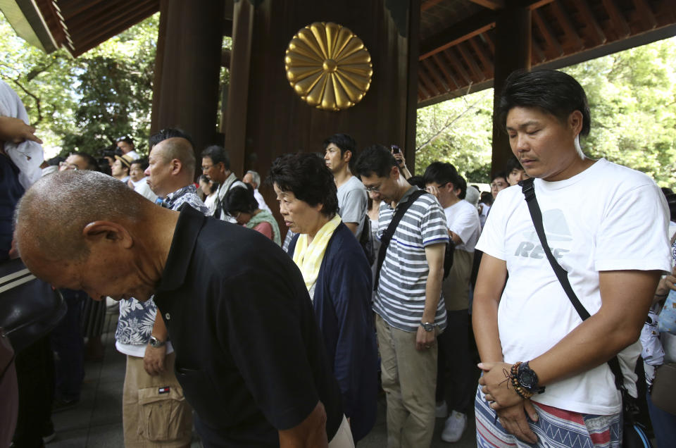 Visitors offer a silent prayer to the war dead at Yasukuni Shrine in Tokyo, Wednesday, Aug. 15, 2018. Japan marked the 73rd anniversary of the end of World War II. (AP Photo/Koji Sasahara)