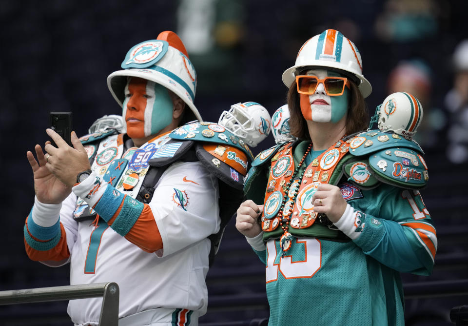 Miami Dolphins supporters arrive for an NFL football game between the Miami Dolphins and the Jacksonville Jaguars at the Tottenham Hotspur stadium in London, England, Sunday, Oct. 17, 2021. (AP Photo/Matt Dunham)