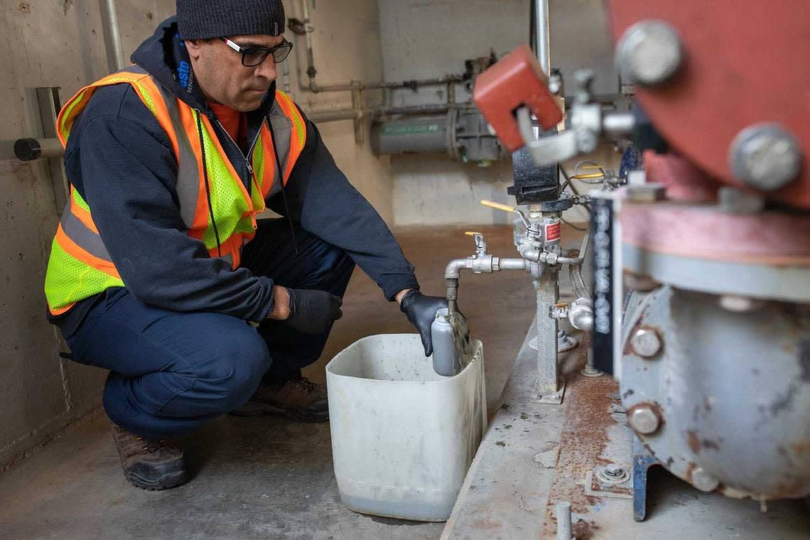 Patrick Green, a utilities plant operator in Modesto, siphons wastewater sludge to be analyzed for evidence of COVID-19. In some parts of California, COVID-19 is in sewage at record-high levels, indicating coronavirus cases may be as bad as in the original omicron surge.