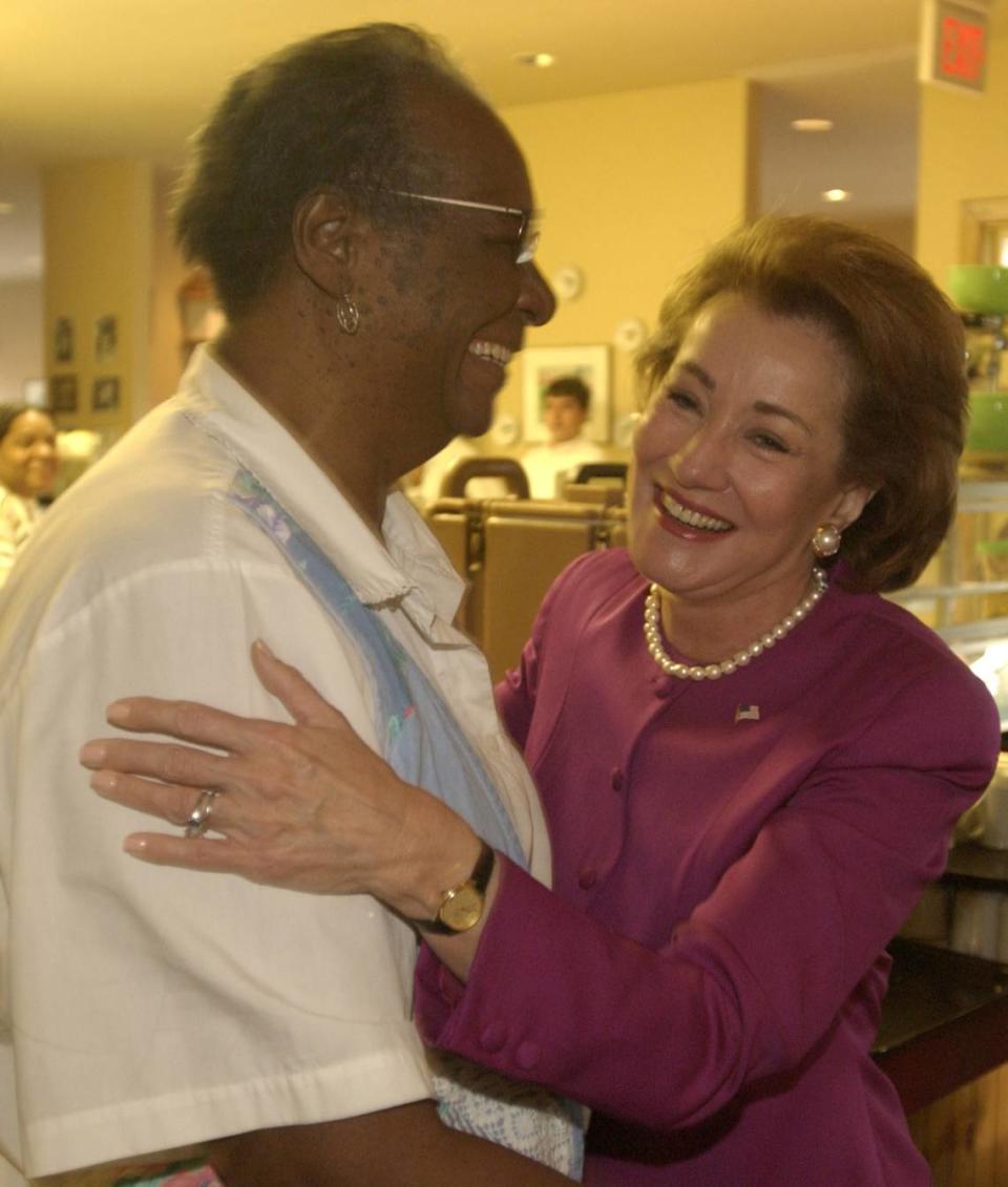 Senate candidate Elizabeth Dole, right, gets a hug from Mildred Council, a.k.a. Mama Dip, Monday, Oct. 22, 2001, during an early-morning visit to Mama Dip’s restaurant in Chapel Hill, N.C.