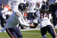 Chicago Bears quarterback Nick Foles (9) fakes a handoff to wide receiver Cordarrelle Patterson (84) during the first half of an NFL football game against the Carolina Panthers in Charlotte, N.C., Sunday, Oct. 18, 2020. (AP Photo/Brian Blanco)