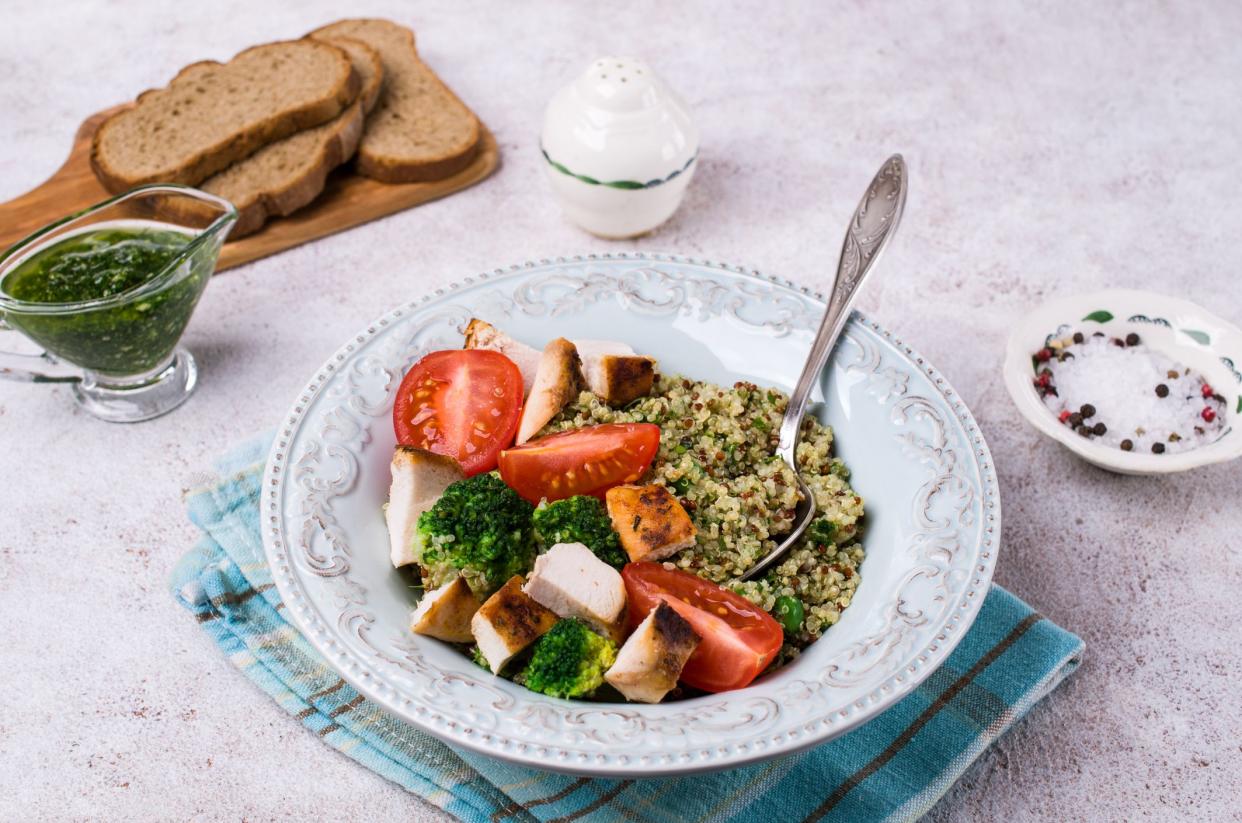 Fried chicken breast slices with quinoa and vegetables. Selective focus.