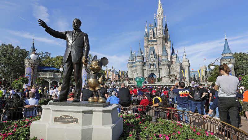 In this Jan. 9, 2019 photo, a statue of Walt Disney and Micky Mouse stands in front of the Cinderella Castle at the Magic Kingdom at Walt Disney World in Lake Buena Vista, Fla. A judge dismissed a federal lawsuit filed by Walt Disney Parks and Resorts against Florida Gov. Ron DeSantis.
