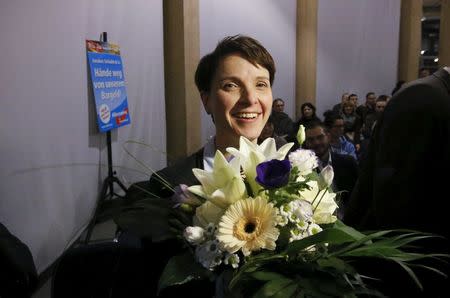 Frauke Petry, chairwoman of the right-wing Alternative for Germany (AFD) holds a bunch of flowers, received after she addresses supporters during a rally for the upcoming Saxony-Anhalt state elections in Bitterfeld, Germany, February 29, 2016. REUTERS/Fabrizio Bensch